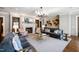 Spacious lounge area with comfortable sofas, armchairs, a fireplace, and a large decorative chandelier at 620 Wade Ave # 506, Raleigh, NC 27605