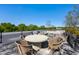 Rooftop deck with comfortable seating, a fire pit, and views of the surrounding trees at 620 Wade Ave # 506, Raleigh, NC 27605