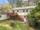 Spacious backyard with a multi-level deck, patio, and a mix of lawn and mature trees at 6216 Lewisand Cir, Raleigh, NC 27615