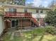 View of the backyard with a two-level deck, patio area, and lush greenery at 6216 Lewisand Cir, Raleigh, NC 27615