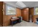 Finished basement area featuring wood paneling, a drop ceiling, and extra storage at 6216 Lewisand Cir, Raleigh, NC 27615
