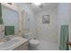 Traditional bathroom featuring patterned wallpaper, white fixtures, and hexagonal tile flooring at 6216 Lewisand Cir, Raleigh, NC 27615