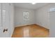 Empty bedroom with hardwood floors and bright window at 6216 Lewisand Cir, Raleigh, NC 27615
