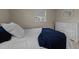 Bright bedroom with a comfortable bed and white dresser, complemented by a navy throw at 6216 Lewisand Cir, Raleigh, NC 27615