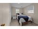 Cozy bedroom with natural light, a single bed with blue throw, and neutral carpeting at 6216 Lewisand Cir, Raleigh, NC 27615