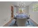 Modern dining room with large table and stylish light fixture, perfect for Gathering gatherings and dinner parties at 6216 Lewisand Cir, Raleigh, NC 27615