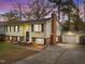 Charming exterior of a two-story home featuring a brick chimney and attached garage with large driveway at 6216 Lewisand Cir, Raleigh, NC 27615