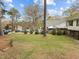 Green front yard with mature trees and a view of the home's exterior at 6216 Lewisand Cir, Raleigh, NC 27615