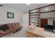 Office area with brown futon, desk, and ample bookshelf space at 6216 Lewisand Cir, Raleigh, NC 27615