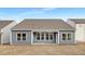 Rear view of home shows covered patio space and ample windows for natural light at 63 Mable Court # 6, Lillington, NC 27546