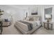 Serene bedroom features soft lighting, a plush bed with neutral linens, and modern decor for a cozy retreat at 63 Mable Court # 6, Lillington, NC 27546