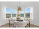 Cozy breakfast nook with round glass table, four chairs, and large windows at 63 Mable Court # 6, Lillington, NC 27546