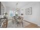 Elegant dining area with stylish table, chairs, chandelier, and natural light at 63 Mable Court # 6, Lillington, NC 27546