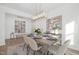 Bright dining room with stylish table, seating for six, modern light fixture, and natural light at 63 Mable Court # 6, Lillington, NC 27546