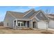 Beautiful craftsman-style home with stone accents, covered porch, and attached two-car garage at 63 Mable Court # 6, Lillington, NC 27546