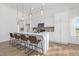 Modern kitchen features a large island with seating, pendant lighting, and white cabinets at 63 Mable Court # 6, Lillington, NC 27546
