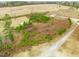 An aerial shot of the property showing a sprawling land with sparse greenery at 65 Chaney Ln, Louisburg, NC 27549