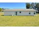 The back of the house features a large grass yard with a sliding glass door at 65 Chaney Ln, Louisburg, NC 27549
