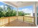 Covered back porch featuring wood flooring, wood railing and ceiling fan overlooking private backyard at 65 Cordoba Dr, Franklinton, NC 27525