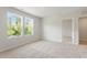 Bedroom with two windows offering serene view of lush greenery and neutral carpeting at 65 Cordoba Dr, Franklinton, NC 27525