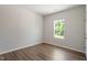 Cozy bedroom with wood flooring, neutral walls, and a window view of the outdoors at 65 Cordoba Dr, Franklinton, NC 27525