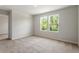 Sunlit bedroom with two windows offering a serene view of lush greenery at 65 Cordoba Dr, Franklinton, NC 27525