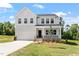 Charming two-story home featuring a covered porch and a two-car garage, set on a well-maintained lawn at 65 Cordoba Dr, Franklinton, NC 27525