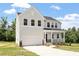 Beautiful two-story home with a covered porch, showcasing classic design elements and a spacious two-car garage at 65 Cordoba Dr, Franklinton, NC 27525