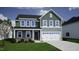 Illustration of two-story home with green siding, stone accents, attached two-car garage and covered front porch at 65 Cordoba Dr, Franklinton, NC 27525