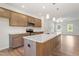 Well-lit kitchen featuring a large island with granite countertops and stainless steel appliances at 65 Cordoba Dr, Franklinton, NC 27525