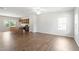 Spacious living room with hardwood floors, connecting seamlessly to the modern kitchen and dining area at 65 Cordoba Dr, Franklinton, NC 27525