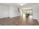 Open-concept living room with hardwood floors, providing a view of the staircase, kitchen, and outdoor scenery at 65 Cordoba Dr, Franklinton, NC 27525