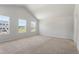 Bright main bedroom featuring multiple windows and plush carpeting at 65 Cordoba Dr, Franklinton, NC 27525