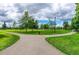 A beautiful community park with walking paths and lush green grass for outdoor recreation at 76 Commons Cir, Clayton, NC 27520