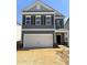 New two-story home featuring a gray exterior, white trim, and a two-car garage at 76 Commons Cir, Clayton, NC 27520