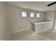 Hallway with three windows that offer natural light; staircase to the right leads to another floor at 76 Commons Cir, Clayton, NC 27520