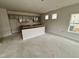 View of a kitchen featuring modern cabinets, a kitchen island, and natural light from windows at 76 Commons Cir, Clayton, NC 27520