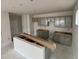View of a kitchen featuring gray cabinets, a kitchen island, and modern recessed lighting at 76 Commons Cir, Clayton, NC 27520