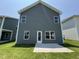This home features a backyard with a concrete patio and a gray exterior with white trim at 76 Commons Cir, Clayton, NC 27520