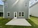 Backyard with a new patio, new sod, and a freshly painted exterior at 76 Commons Cir, Clayton, NC 27520