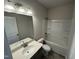 Well-lit bathroom with a shower-tub, toilet, and granite vanity at 76 Commons Cir, Clayton, NC 27520