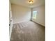 Cozy bedroom with neutral carpet, and a bright window at 76 Commons Cir, Clayton, NC 27520