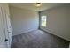 Cozy bedroom with plush carpeting, a neutral palette, and a bright window at 76 Commons Cir, Clayton, NC 27520