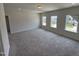 Bonus room with plush carpeting and natural light from the window at 76 Commons Cir, Clayton, NC 27520