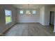 Dining room with sleek floors, decorative chandelier, and multiple windows for a bright, open space at 76 Commons Cir, Clayton, NC 27520