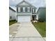 Charming two-story home with a two-car garage and well-maintained front lawn at 76 Commons Cir, Clayton, NC 27520