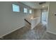 Bright hallway with plush carpeting, natural light, and neutral decor at 76 Commons Cir, Clayton, NC 27520