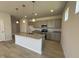 Modern kitchen with granite countertops, stainless steel appliances, and an island with pendant lighting at 76 Commons Cir, Clayton, NC 27520