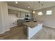 Modern kitchen with granite countertops, stainless steel appliances, and a spacious island with a sink at 76 Commons Cir, Clayton, NC 27520