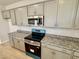 Modern kitchen features stainless steel appliances and granite countertops at 76 Commons Cir, Clayton, NC 27520